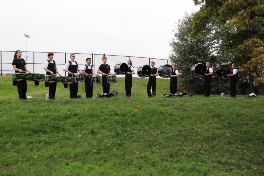 The drumline warms up in their designated area.
