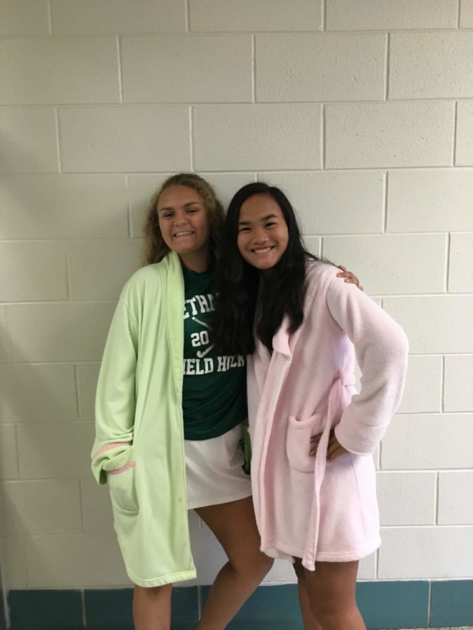 (from left) Sophomores Juliette Louer and Ava Probst wear robes for their field hockey game.

