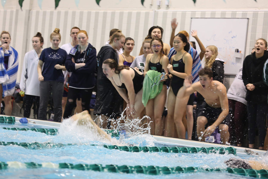 Girls from the team cheer on their teammates during the 400 free relay. 
