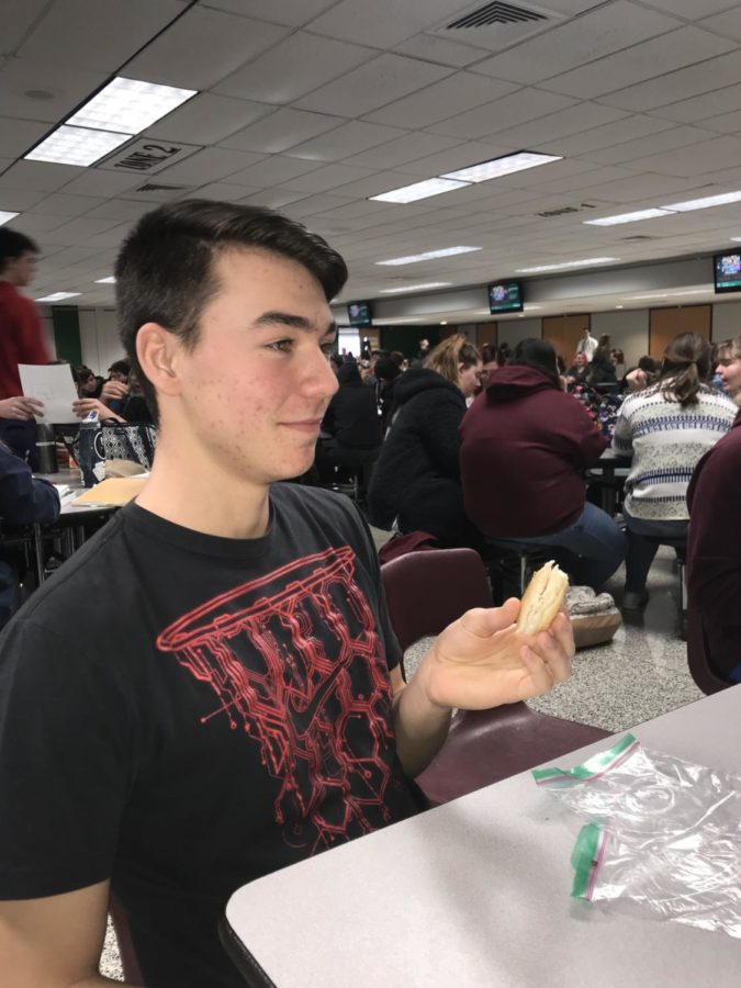 Jeffrey Cooper, a sophomore, eats a bagel sandwich at lunch.   
