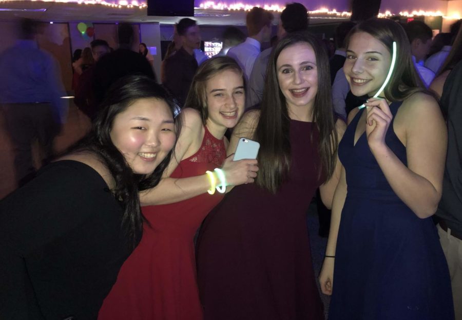Junny Lee, Ruby Murray, Mikayla Sheedy, and Elena Snodgrass embrace the glow theme by wearing glow sticks for the dance.
