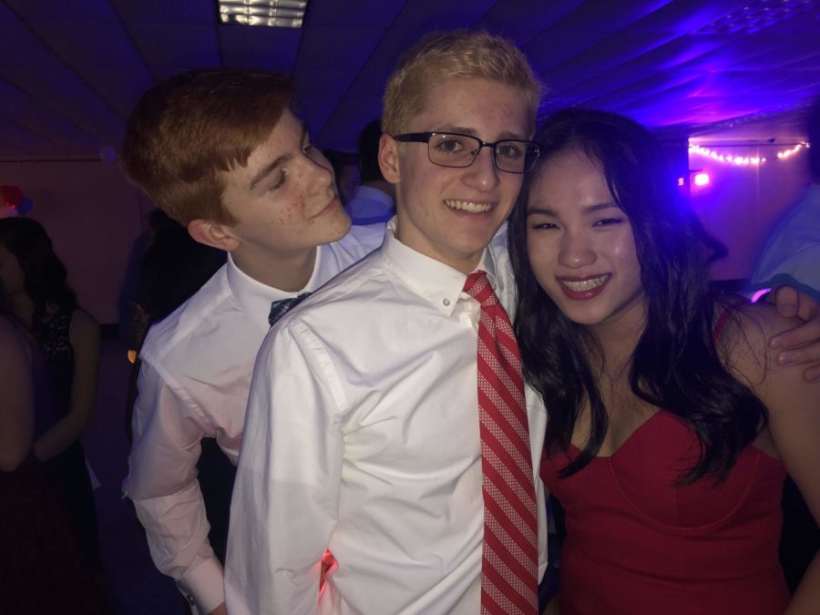 Amy Zhang and Tommy Gibbs get photobombed by Nate Reiss.
