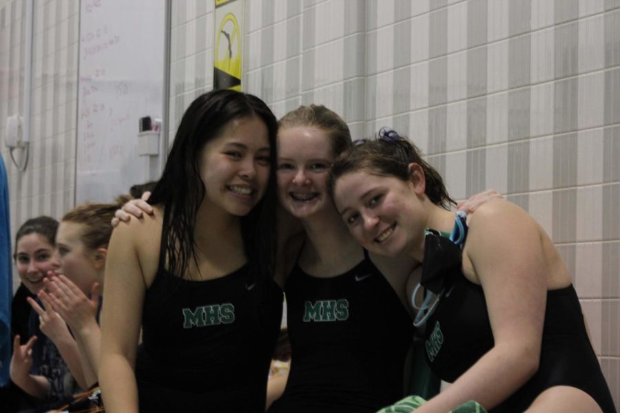 (from left) Freshmen Amy Nguyen, Alyssa Griffin and Anna Cardaci are cheered on senior Sara Fleck in the 500 freestyle. 
