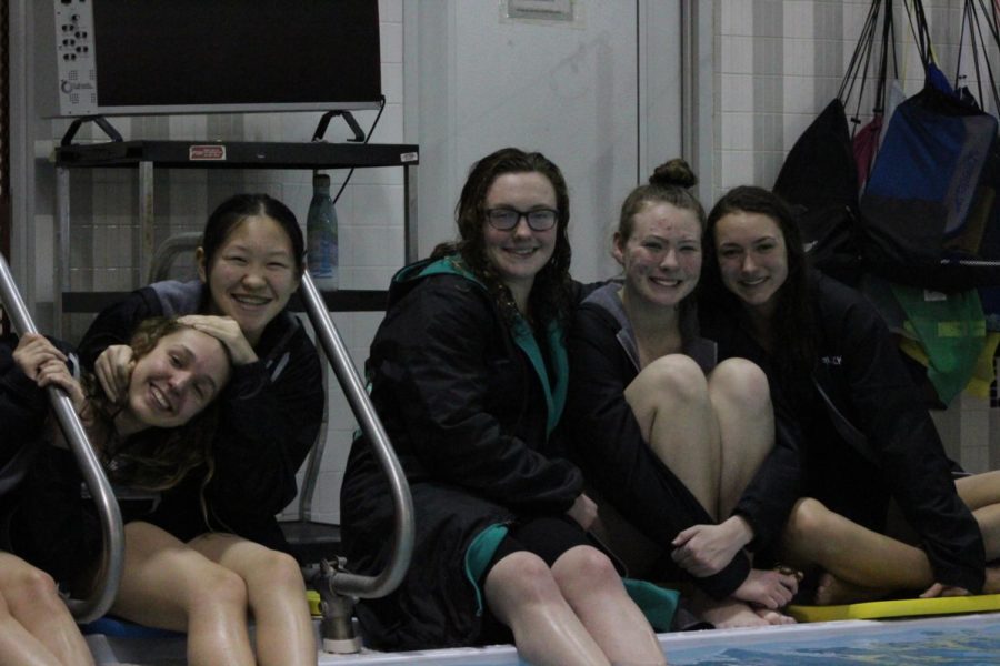 (from left) Hailey McGarity, Stephanie Yu, Erin Valle, Kerri Drum and Rachel Prusacki sat poolside to watch their teammates dive.  
