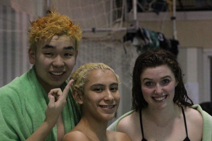 (From left) Robin Wang, Nathan Boardman and Grace McGlynn discussed the boys team’s annual hair bleaching. 
