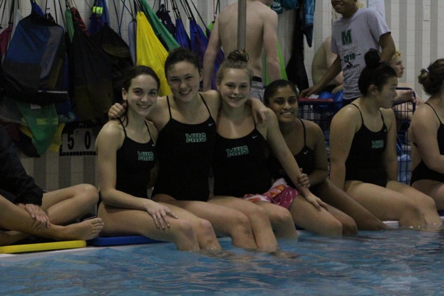 (From left) Hannah Taylor, Alex Ferrance, Sophia Leber and Josephine James rooted for seniors Max Markowitz and Hayden Aubrey during the diving portion of the meet. 
