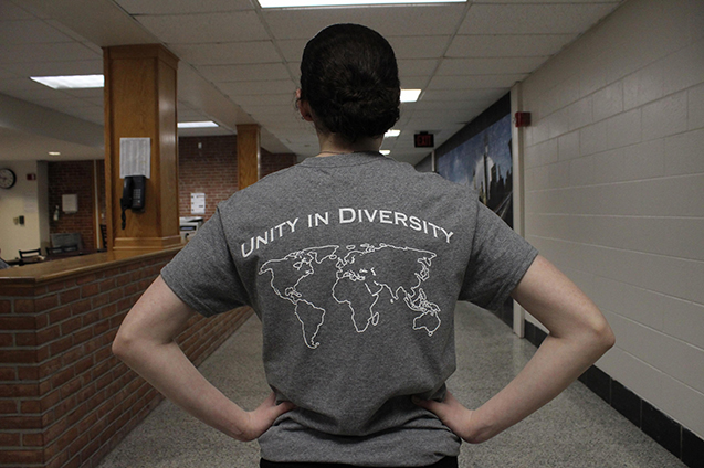 Abby Thornton, freshman, displays one the Multicultural Club shirts worn by club members at the fundraiser.
