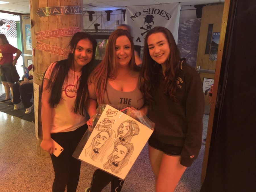 (from left) Preet Boiwala, Zoe LaPaglia and Elizabeth Kirsch show off their caricature.  
