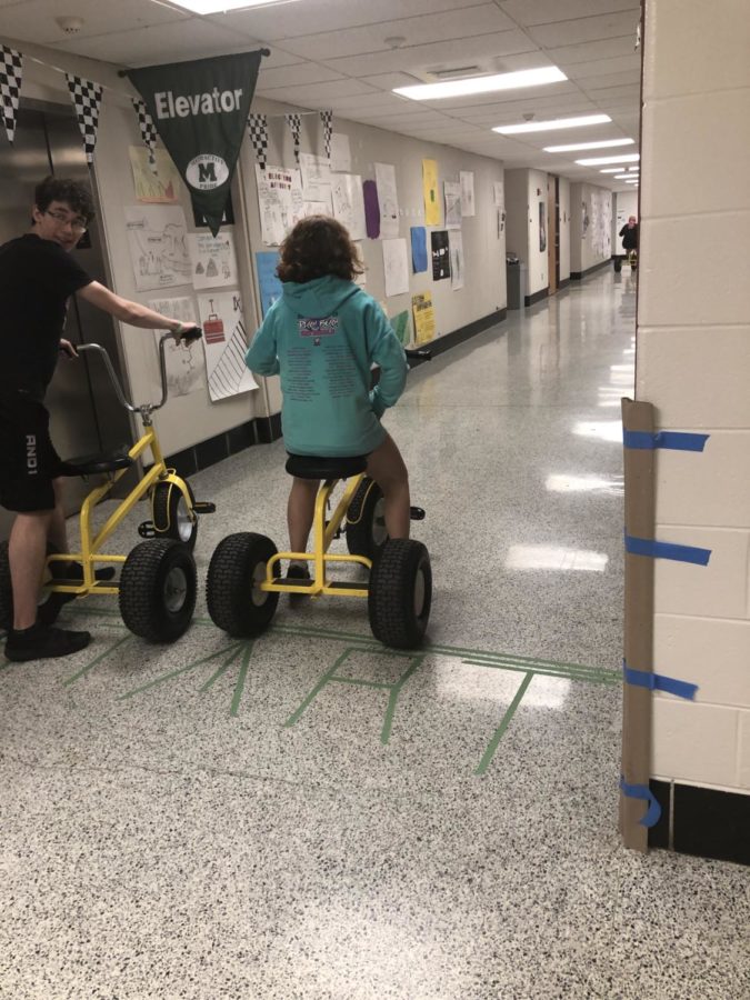 Summer Elsayed and Brendan Ferradji line up at the starting line for their tricycle race.  
