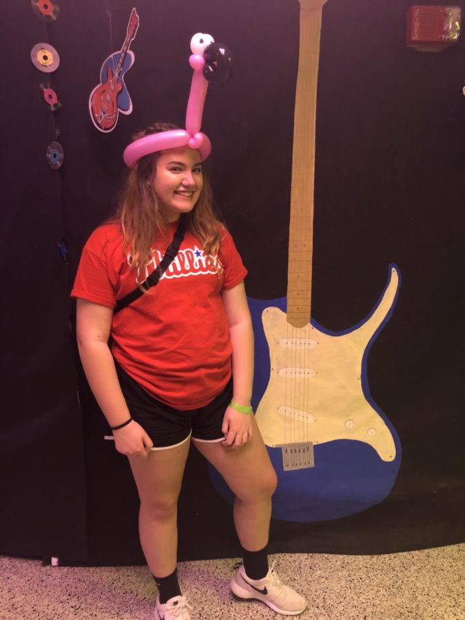 Camille Conard, a junior, poses with her flamingo hat made by the balloon artist. 
