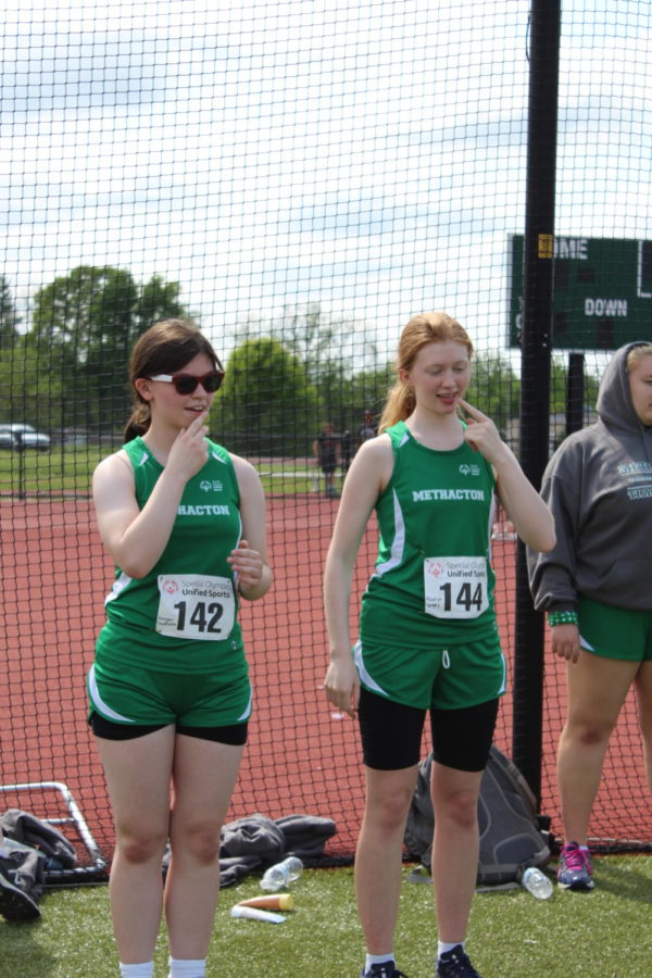 Freshmen Regan and Madelyn practiced their national anthem sign language prior to the meet.
