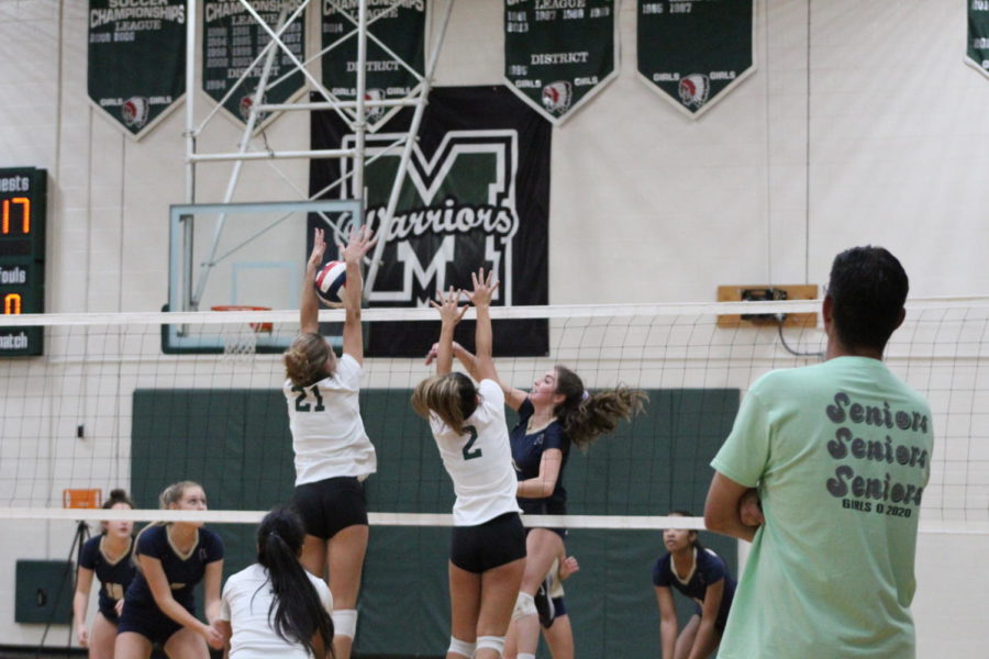Claire Claudy (left) blocks an attack from the opposing side.
