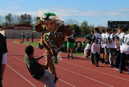 The Warrior mascot danced with a student while teams were announced.