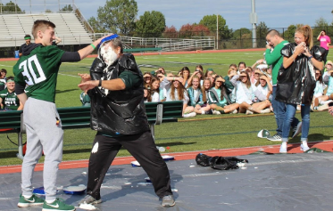 Nick DiSabatino coats Mr. Cardillo in a whipped cream pie to end the charity segment of the pep rally.