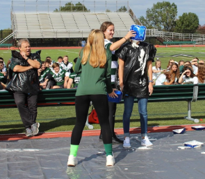Sophomore Sarah Kenwood smashes a pie to face of math teacher Ms. Crist.