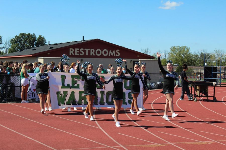 The cheerleading squad makes its entrance into the pep rally.

