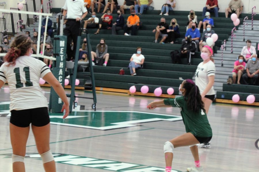 Mianna Ly, in green, plays libero for the team on Dig Pink night.
