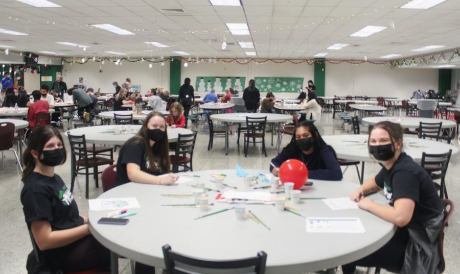 (from left) Freshmen Maggie Petren, Kathleen Kenny, Kristi Thomas and Jackie Cohen, Habitat volunteers, paint pictures during the event.

