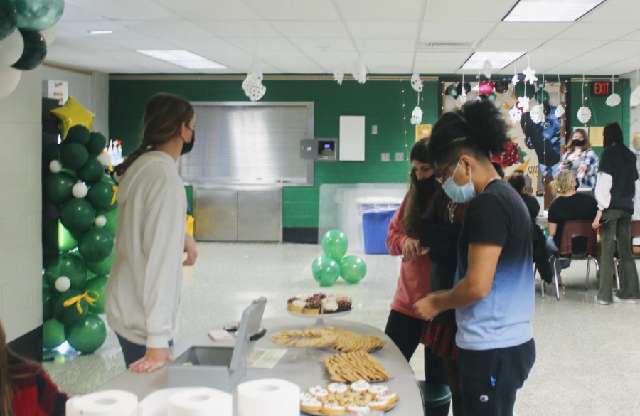 Megan Lineen (left) sells cookies to Methacton students to support Habitat for Humanity.
