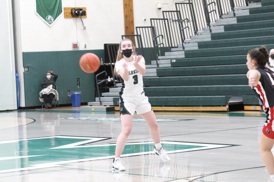Point guard Cassidy Kropp sends a pass out wide during early first quarter action. 