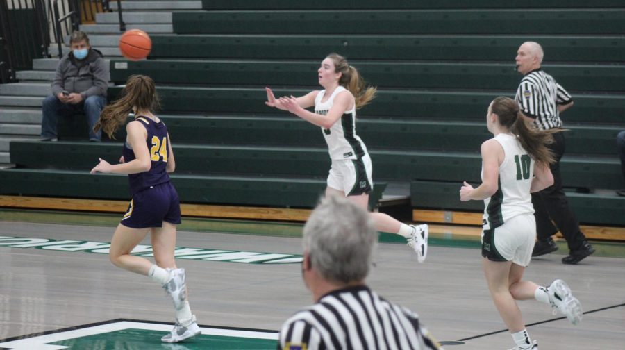 Cassidy Kropp distributes the ball as the Warriors hustle down on offense. 