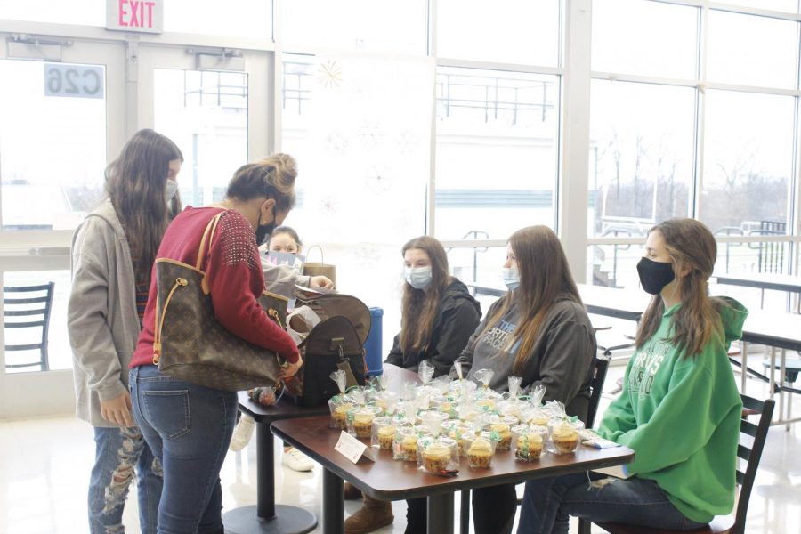 (seated from left) Bethannie Murphy, Olivia Branca and Alaina Fazzini sold baked goods that they volunteered to make.
