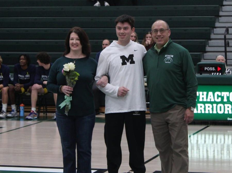 Senior Owen Goldstein stands with his parents before the game at center court. He plans to go to college for business.
