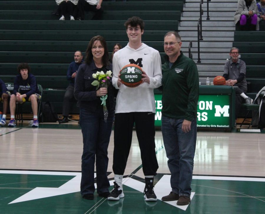 Senior Evan Spang stands with his parents prior to tip off. His favorite basketball memory was making the game winner against Father Judge earlier this season.
