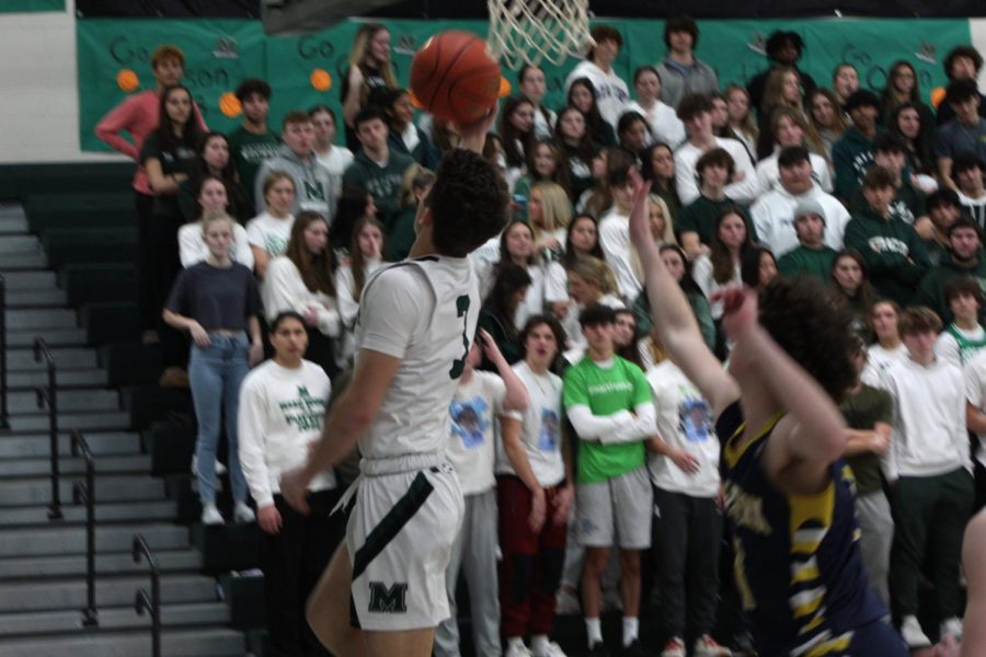 Senior Jason Lagana drives by his defender on the baseline for a reverse layup.
