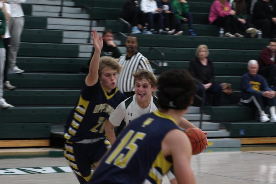 Senior Cam Chilson gets around his defender and drives to the hoop for a layup opportunity.
