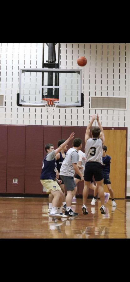 Senior Jake Chapman takes a three-pointer over PJ Duffy.