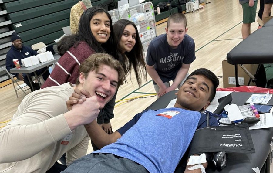 Donor Varun Jayaram gets encouragement from student volunteers as he gives blood