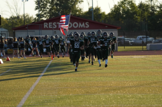 Captain Collin O’Niel bringing out the team holding the American flag vs PW