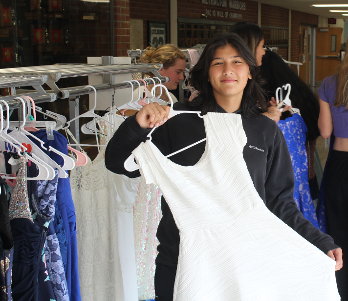Aselle Zabun holds up a white dress that was for sale at the annual girls soccer fundraiser on Sept. 21.

