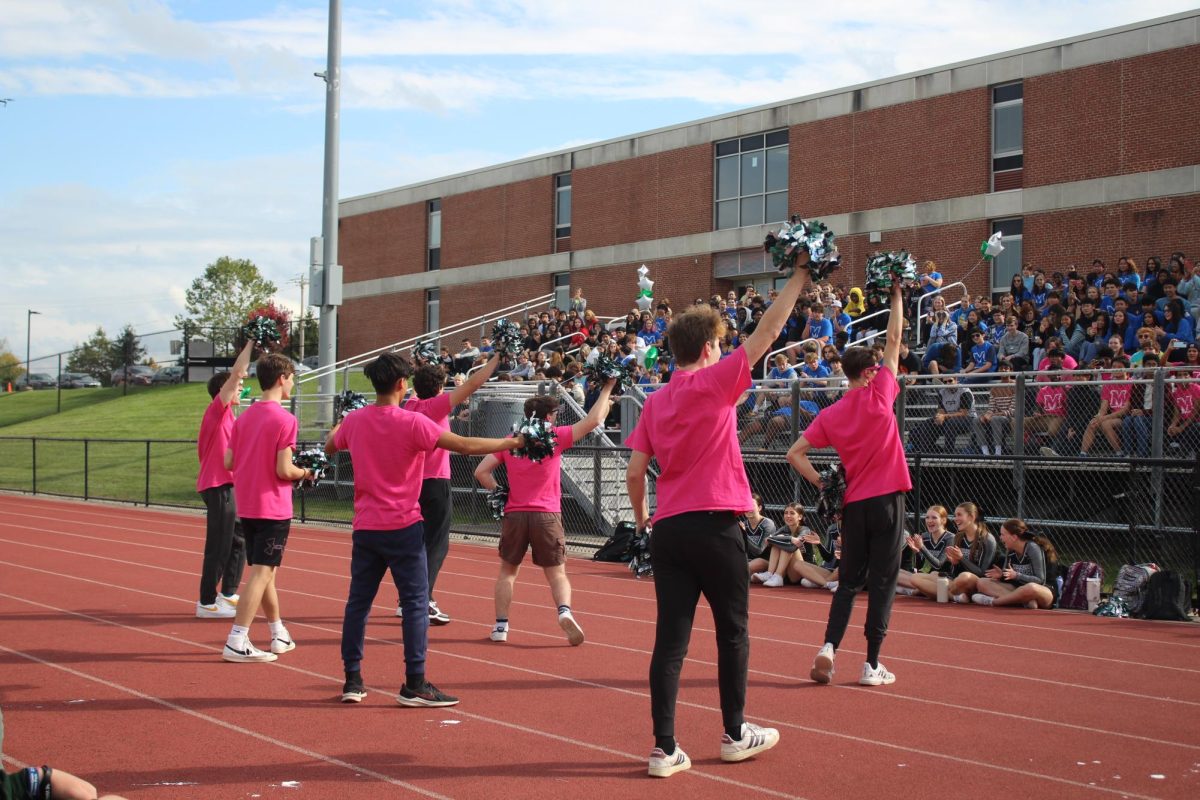 Volunteering to cheerlead, some of the senior boys got the crowd energized during the Powder Puff game.
