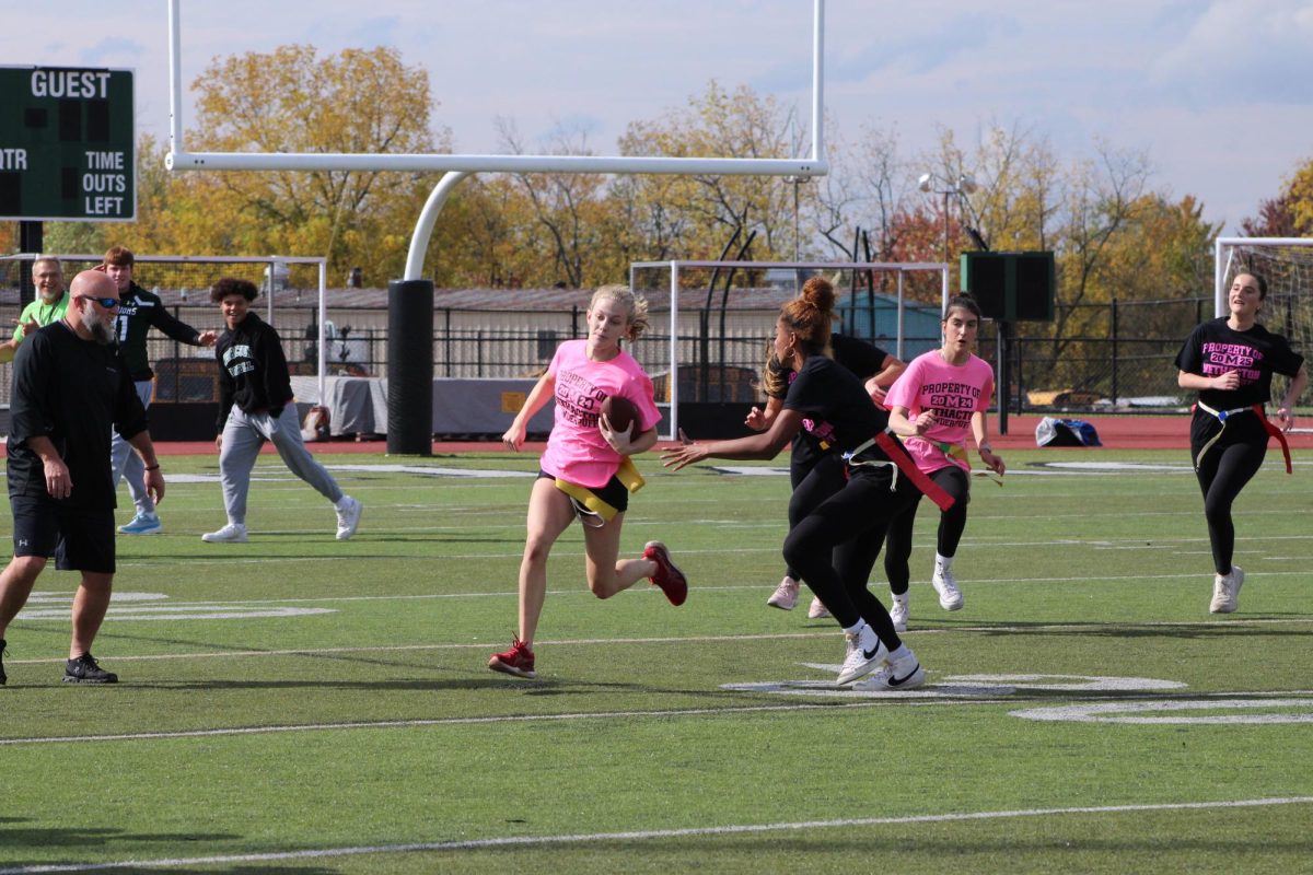 Senior Summer Mellow attempts to run by junior Avalina Willis in early Powder Puff action on Oct. 20. The game would end in a 7-7 tie. 