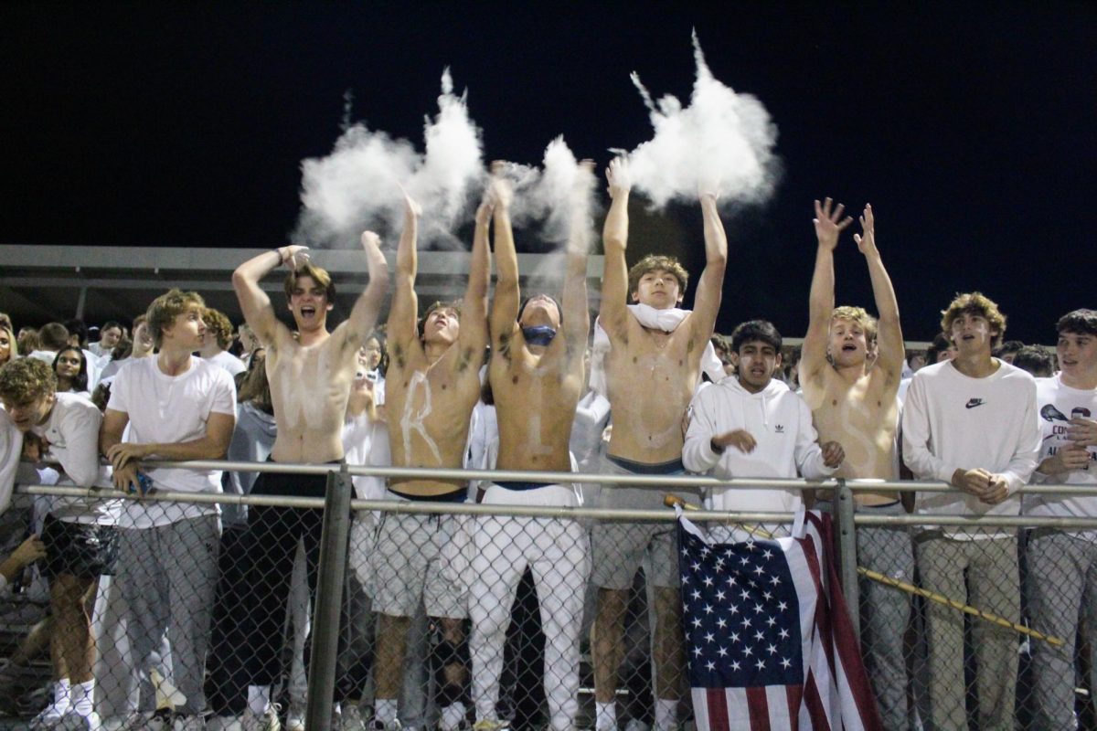 Methacton juniors and seniors threw baby powder into the air to hype the crowd near the Homecoming games start. 
