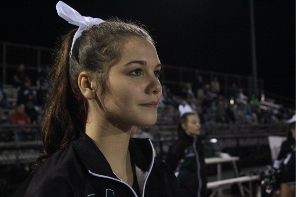 Cheerleader Sadie Emerson waits for her squads next moment to get the crowd into the game.
