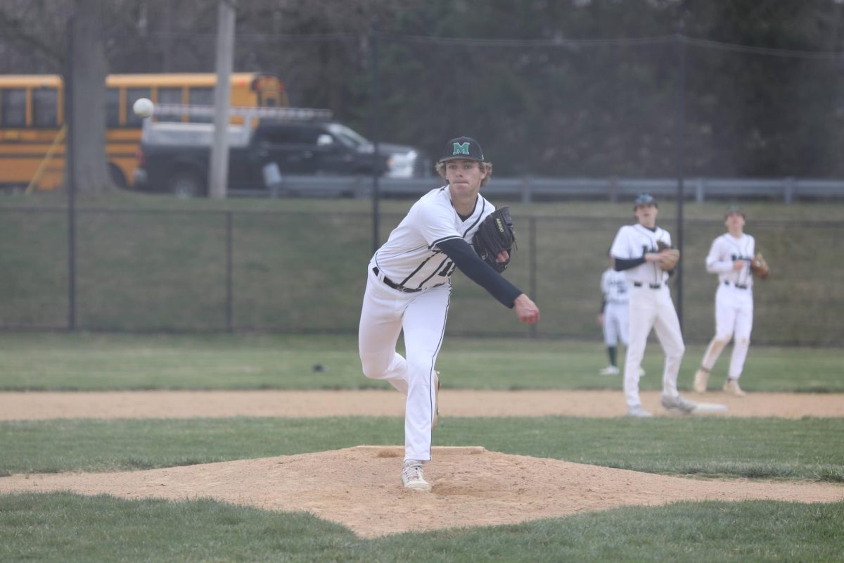 Evan Jones throws a warm-up pitch before the game against Lansdale Catholic. Jones has been the Warriors ace throughout the season. 
