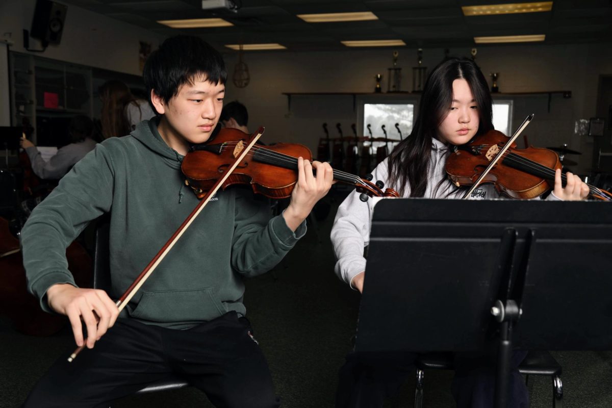 Jeffrey and Victoria Fan warm up prior to their chamber orchestra practice on Feb. 28. Victoria, the chamber's first chair, will be continuing her education at the University of Penn. Jeffrey will move on to his sophomore year at MHS after earning an Overall Bronze medal at the Academic Decathlon Eastern Regional Championship in early February.