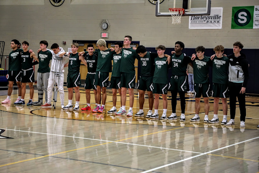 The entire varsity boys basketball team during the national anthem prior to a top ranked PAC matchup at Pope John Paul II