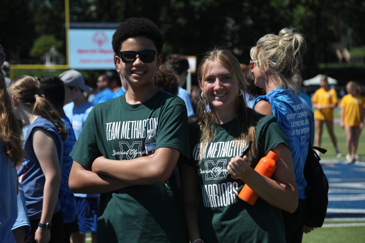 Chase Hoven and his buddy, Calie Fisher, stand on the infield after the softball throw.
